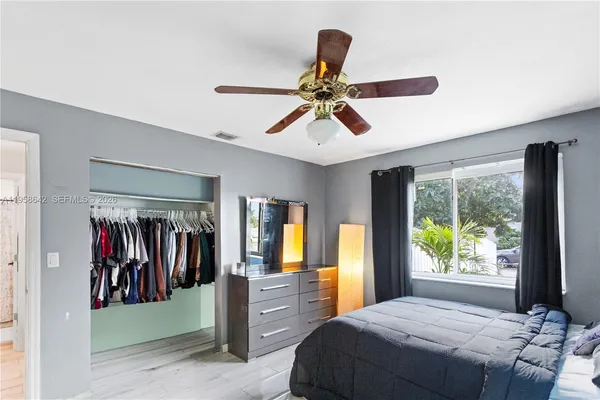 a bed room with a bed and a window