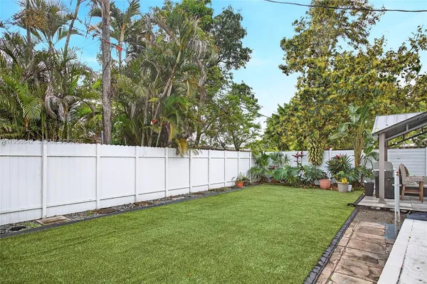 a view of a backyard with large trees
