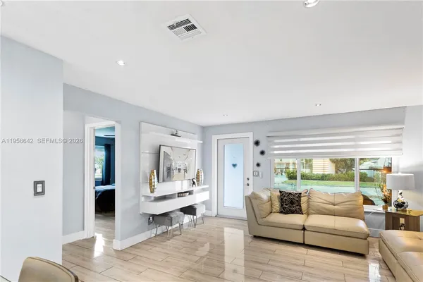 a living room with furniture and a large window