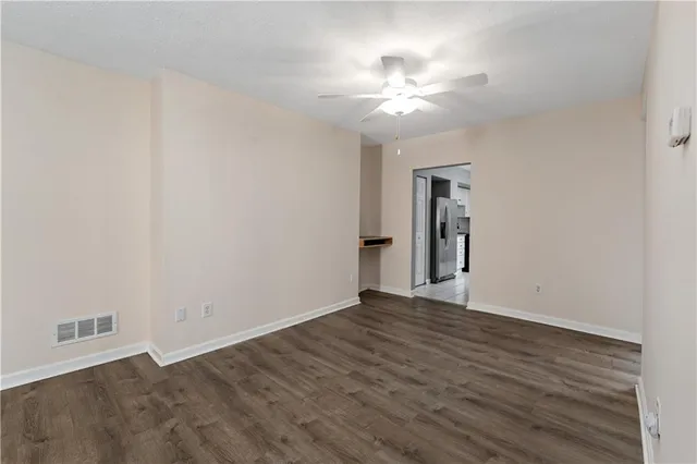 a view of an empty room with wooden floor