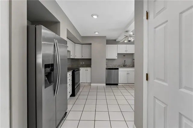 a kitchen with stainless steel appliances granite countertop a refrigerator and a sink