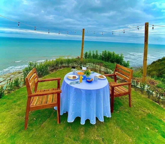 a view of a chairs and table on the wooden deck
