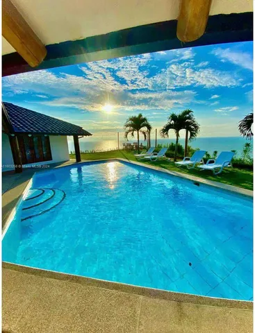 a view of swimming pool with seating area
