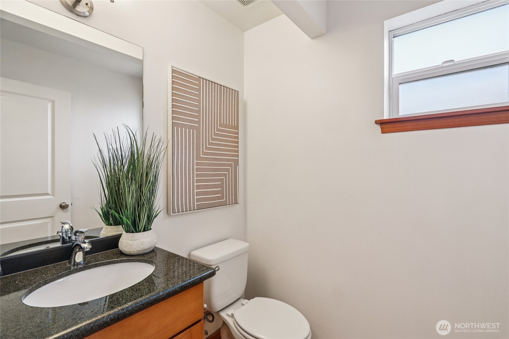 14539 32nd Avenue Northeast, Unit A Shoreline, WA 98155 - Photo 11 of 27 a bathroom with a granite countertop sink and a mirror