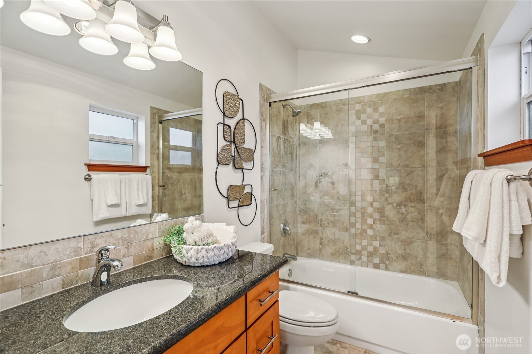 14539 32nd Avenue Northeast, Unit A Shoreline, WA 98155 - Photo 17 of 27 a bathroom with a granite countertop sink toilet mirror and shower