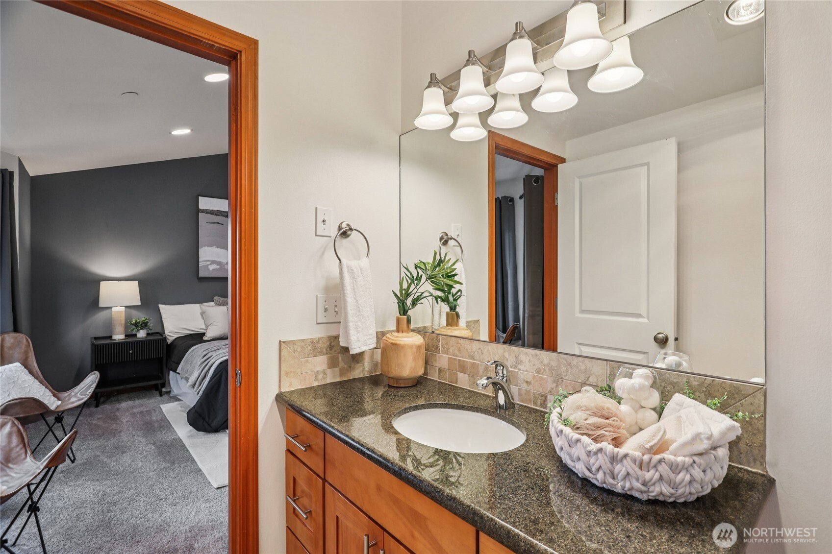 14539 32nd Avenue Northeast, Unit A Shoreline, WA 98155 - Photo 18 of 27 a en suite bathroom with a granite countertop sink and a mirror