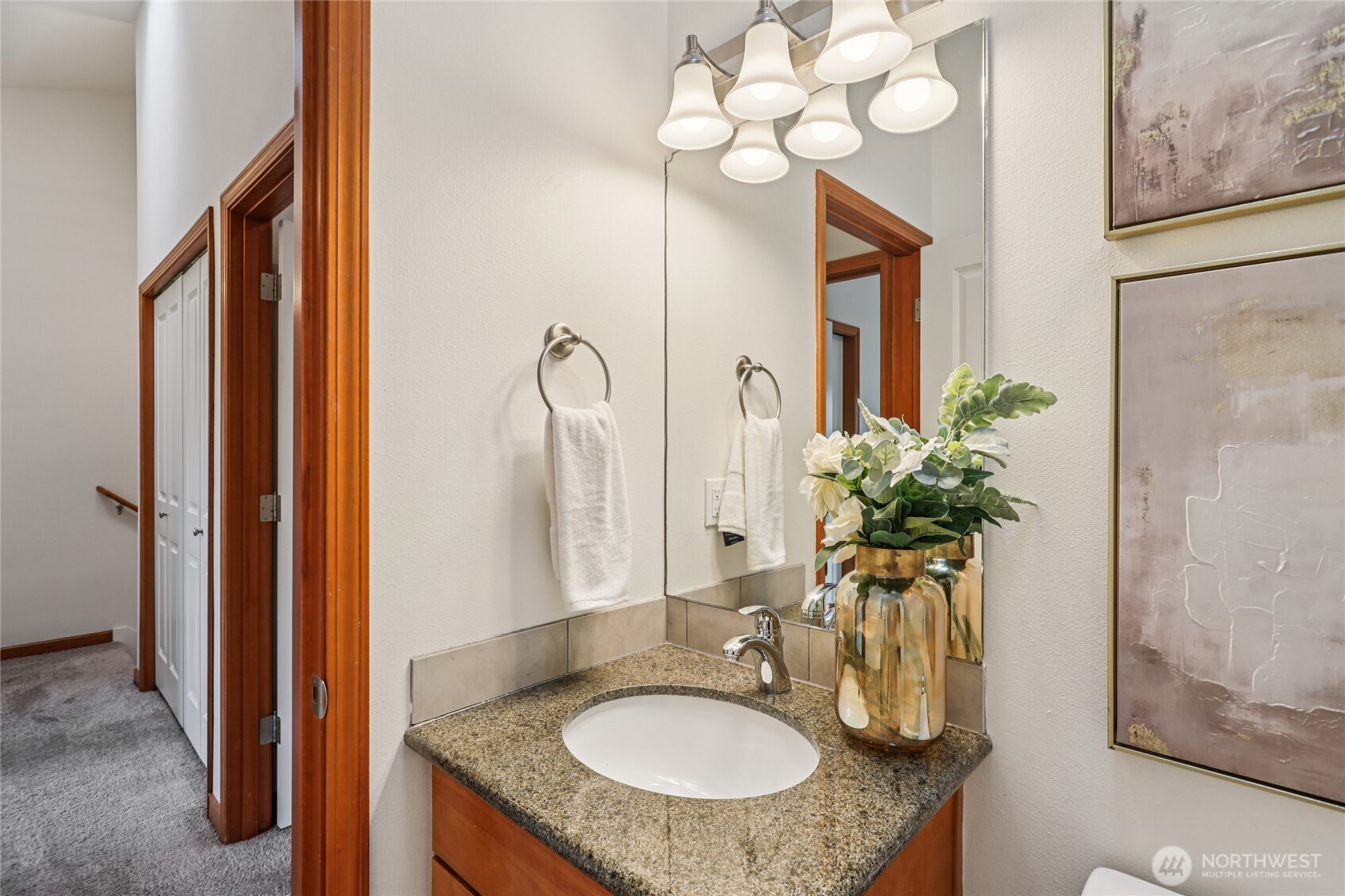 14539 32nd Avenue Northeast, Unit A Shoreline, WA 98155 - Photo 23 of 27 a bathroom with a granite countertop sink a mirror and a potted plant