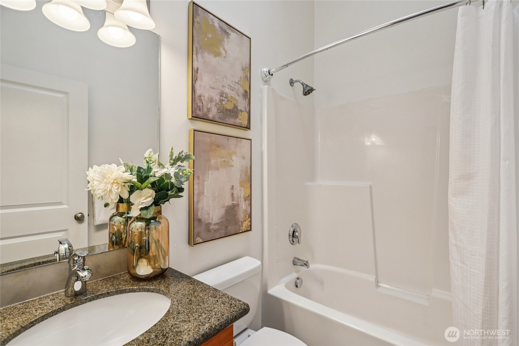 14539 32nd Avenue Northeast, Unit A Shoreline, WA 98155 - Photo 24 of 27 a bathroom with a granite countertop sink a toilet and shower