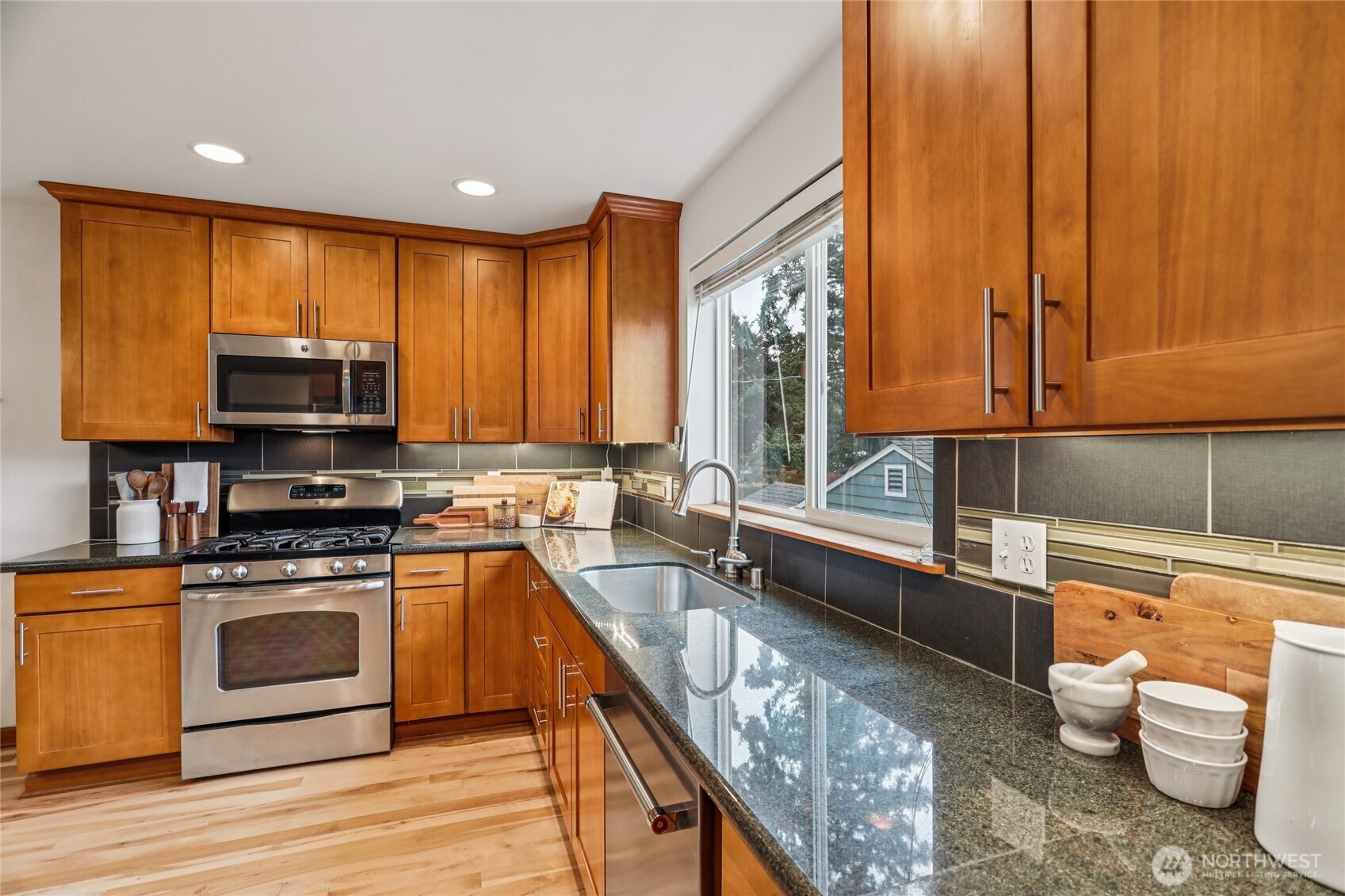 14539 32nd Avenue Northeast, Unit A Shoreline, WA 98155 - Photo 10 of 27 a kitchen with a stove a sink and a microwave