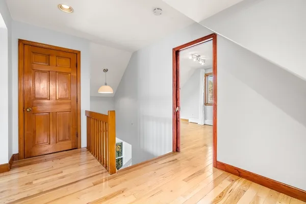 a view of an empty room with wooden floor