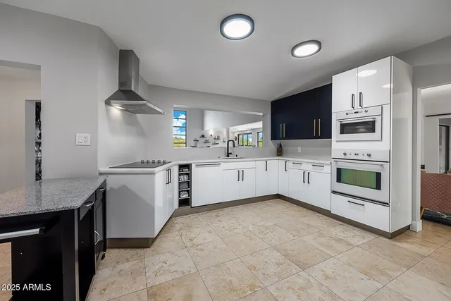 a kitchen with stainless steel appliances kitchen island granite countertop a sink and cabinets