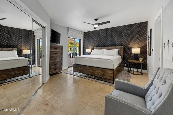 a bedroom with a bed and a couch