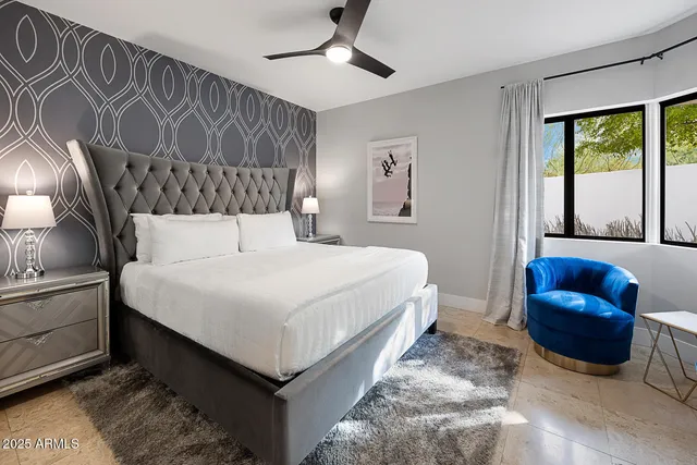 a bedroom with a bed couch and window