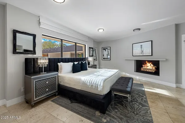 a bedroom with a bed and a television