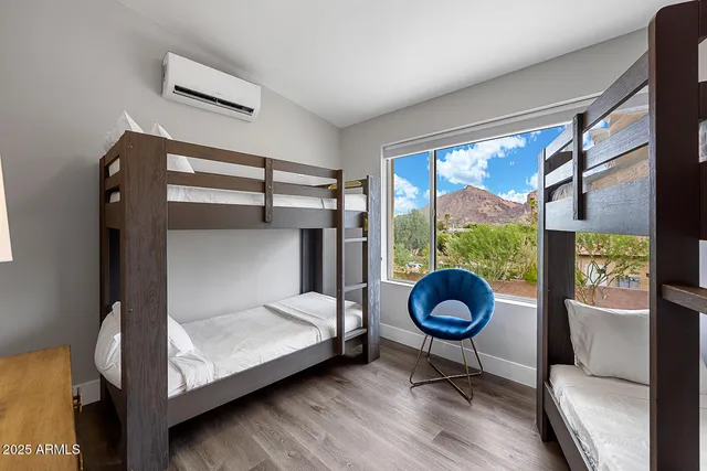 a bedroom with a bed and a floor to ceiling window