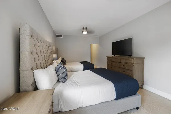 a bedroom with a bed and a flat screen tv