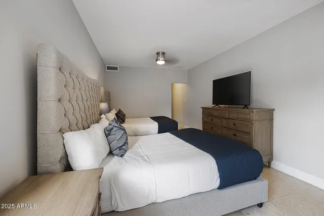 a bedroom with a bed and a flat screen tv