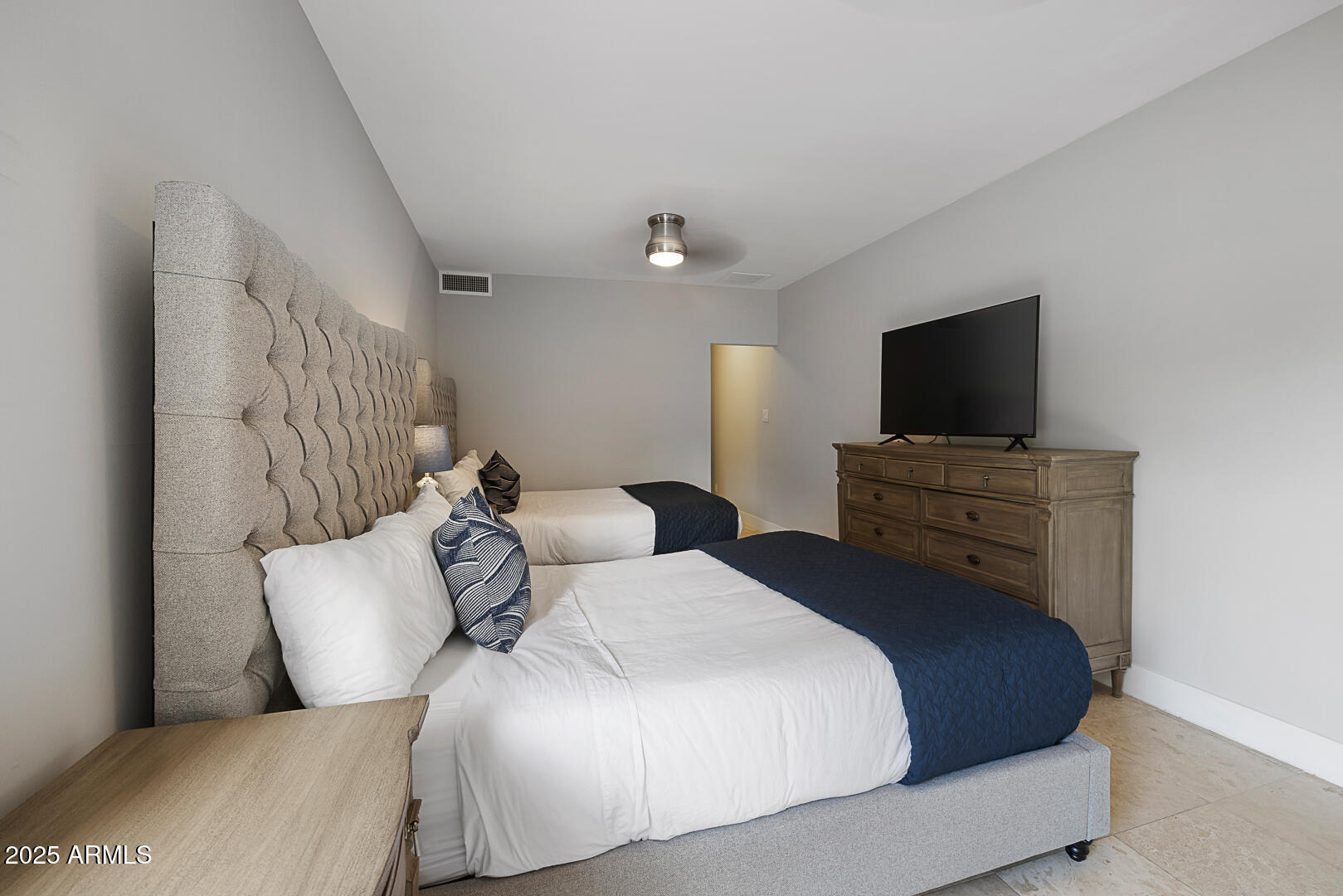 7111 North Quartz Mountain Road Paradise Valley, AZ 85253 - Photo 19 of 22 a bedroom with a bed and a flat screen tv