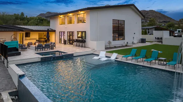 an aerial view of a house with swimming pool garden and patio