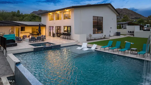 an aerial view of a house with swimming pool garden and patio