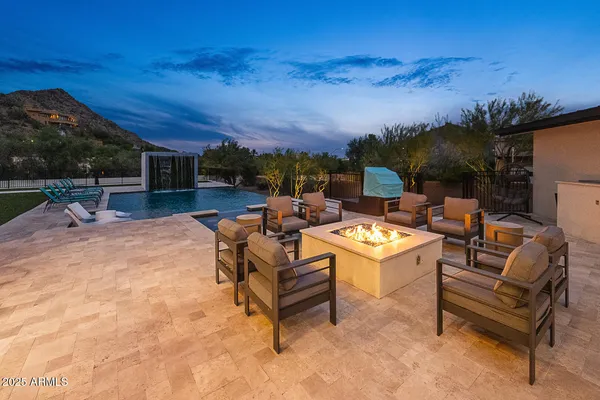 a view of a terrace with furniture and a fire pit
