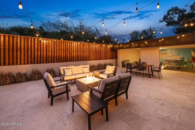 a backyard of a house with table and chairs
