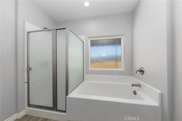 a bathroom with a bathtub and a shower