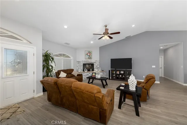 a living room with furniture a flat screen tv and a window