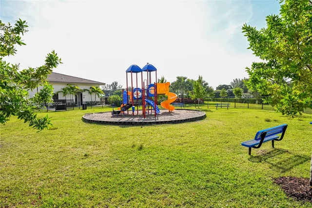 a swimming pool with lawn chairs and plants