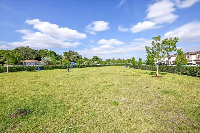 a view of a garden with a building in the background