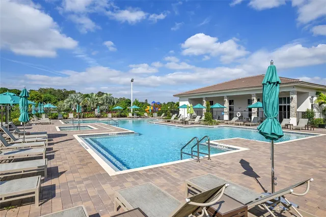 a view of a patio with couches and table and chairs and potted plants