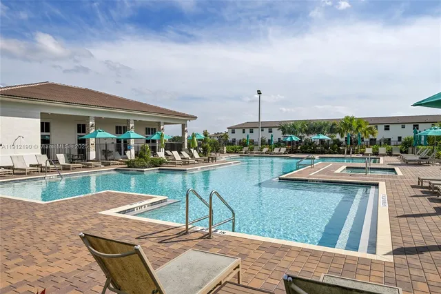 a view of swimming pool with outdoor seating and plants