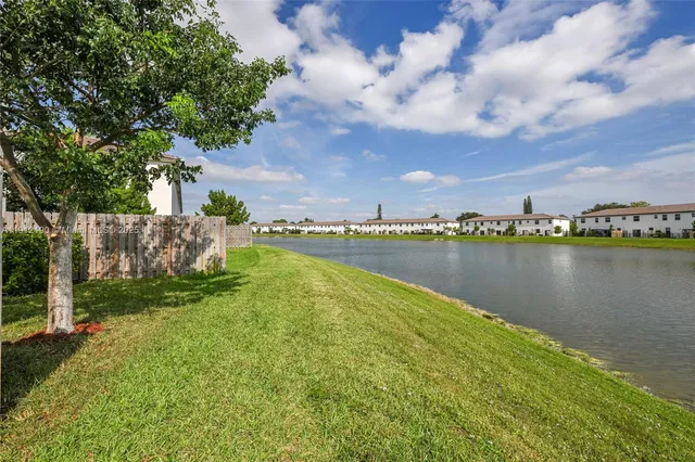 a view of a lake with houses in the back