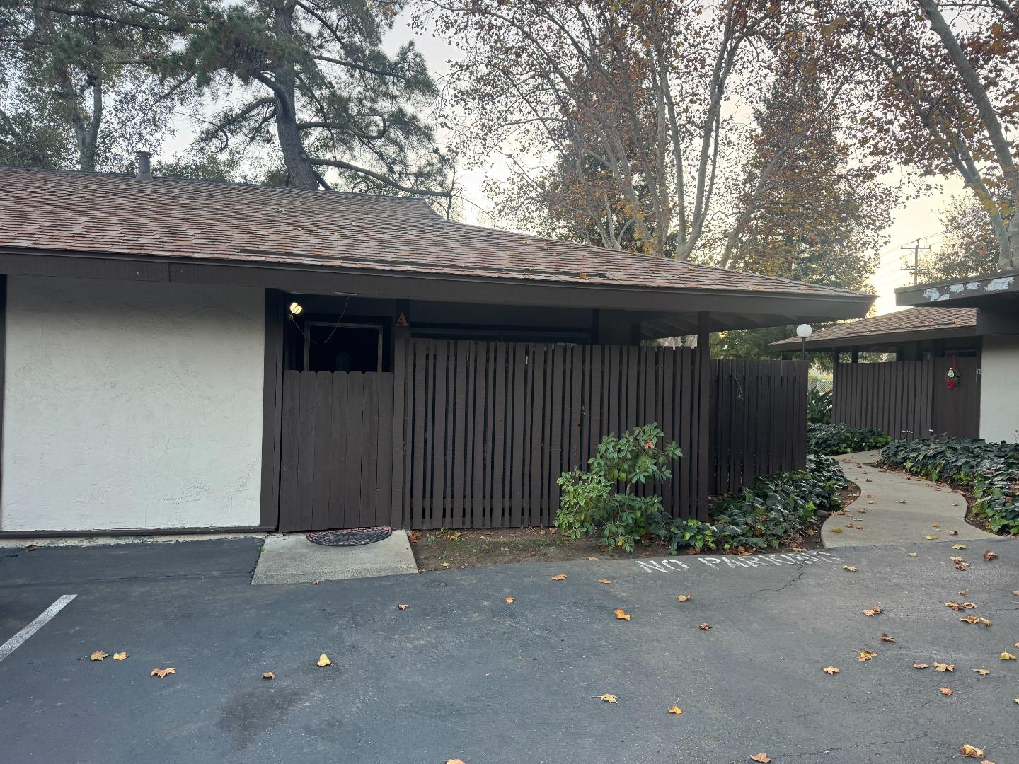 a backyard of a house with plants and trees