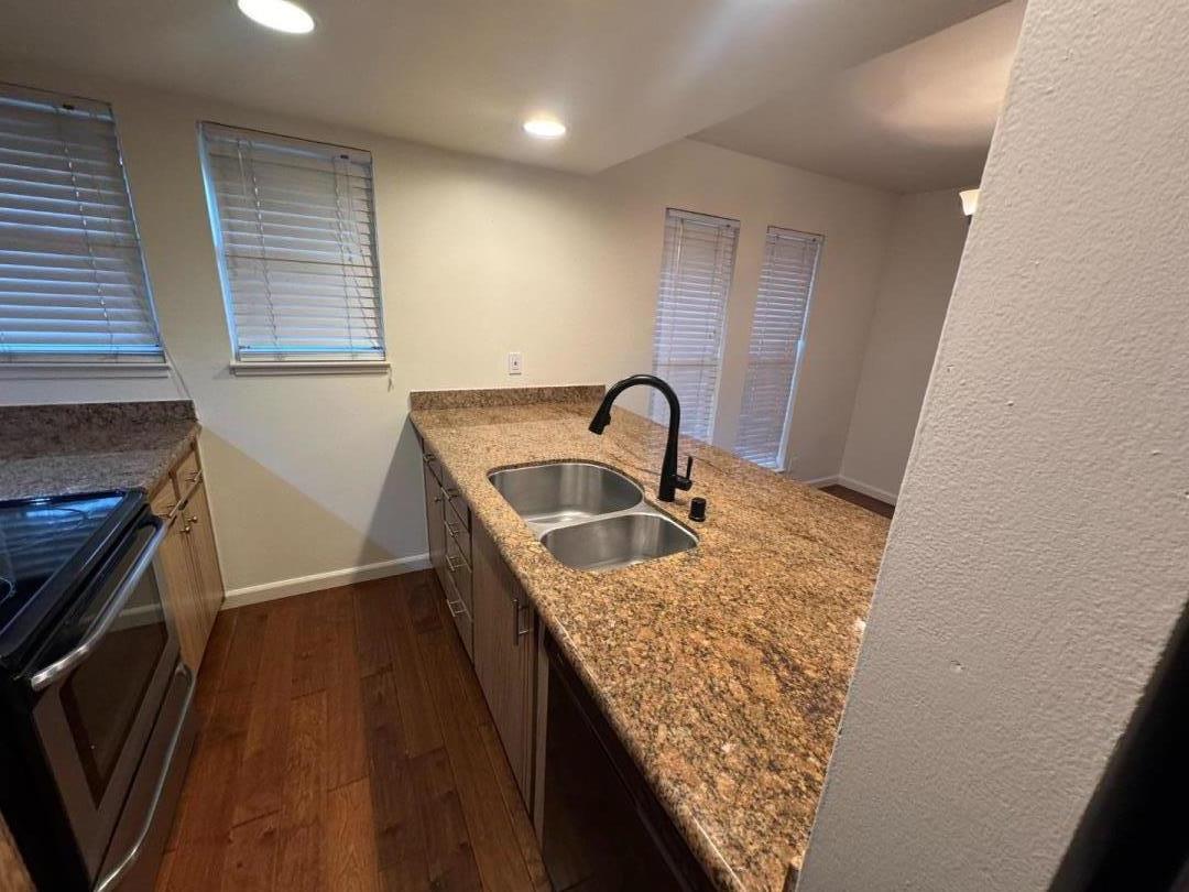 5434 Roundtree Court, Unit A Concord, CA 94521 - Photo 5 of 10 a kitchen with a sink stove and cabinets