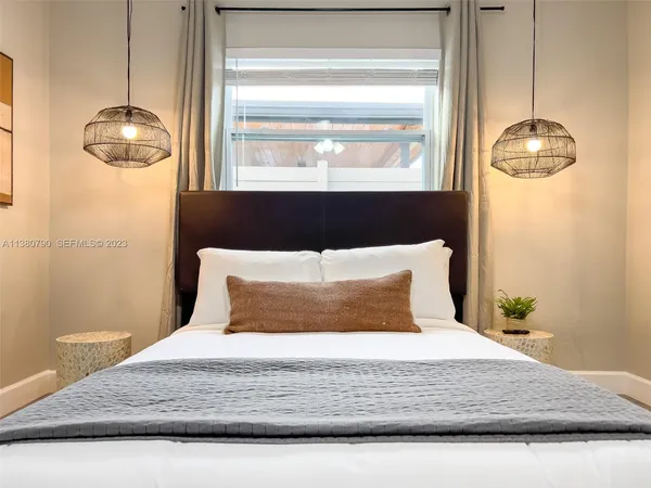 a bedroom with a bed and window