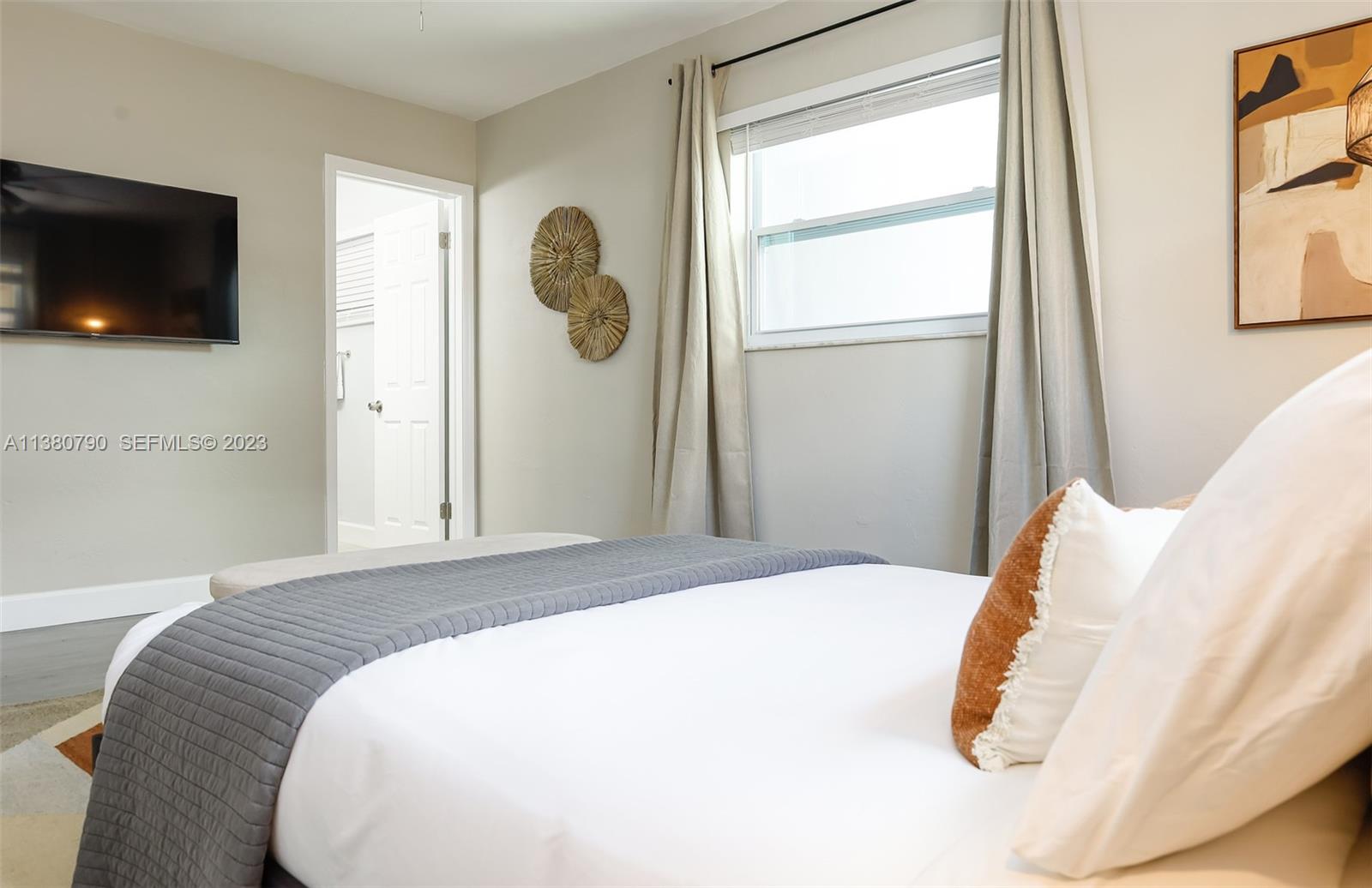 2761 Southwest 33rd Avenue, Unit 2 Miami, FL 33133 - Photo 15 of 33 a bedroom with a bed and a flat screen tv