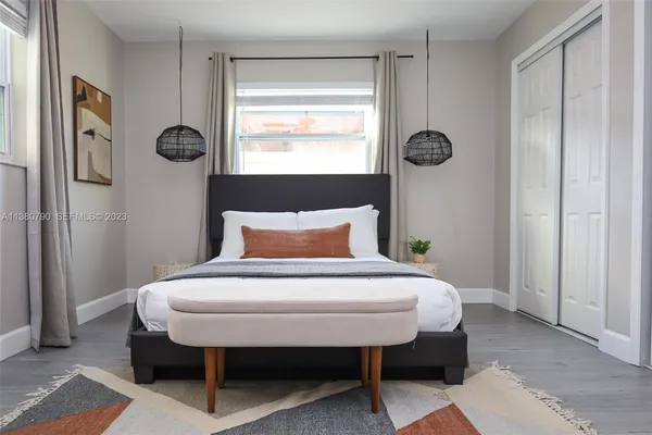 a bedroom with a bed and a window