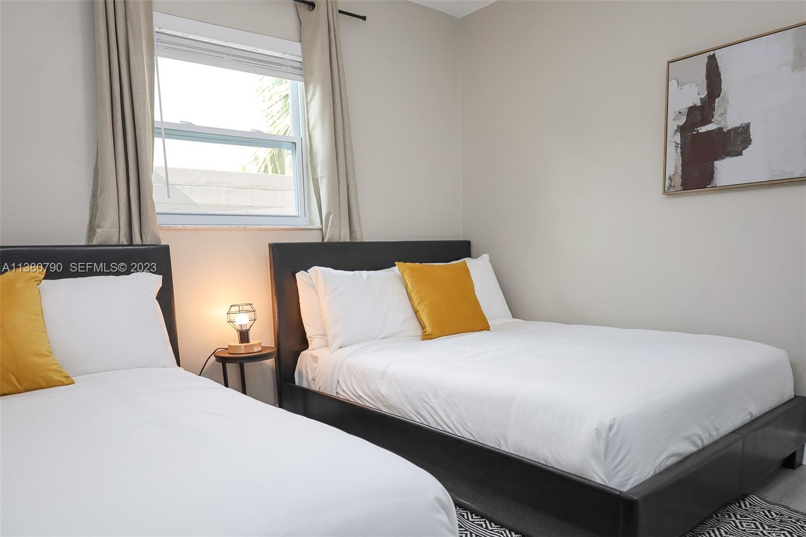 2761 Southwest 33rd Avenue, Unit 2 Miami, FL 33133 - Photo 21 of 33 a bedroom with two beds and a window