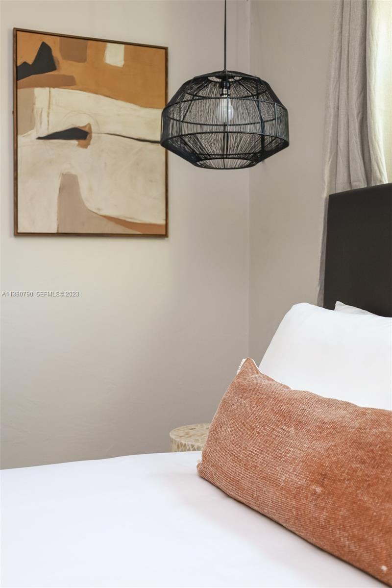 2761 Southwest 33rd Avenue, Unit 2 Miami, FL 33133 - Photo 24 of 33 a bedroom with a bed and a painting on the wall