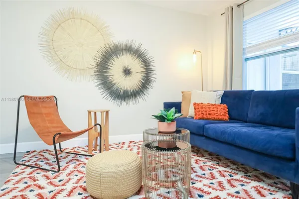 a living room with furniture and a potted plant