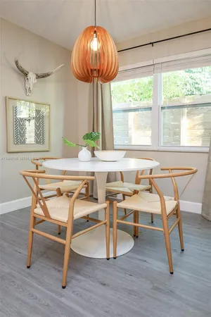 a view of a dining room with furniture window and wooden floor