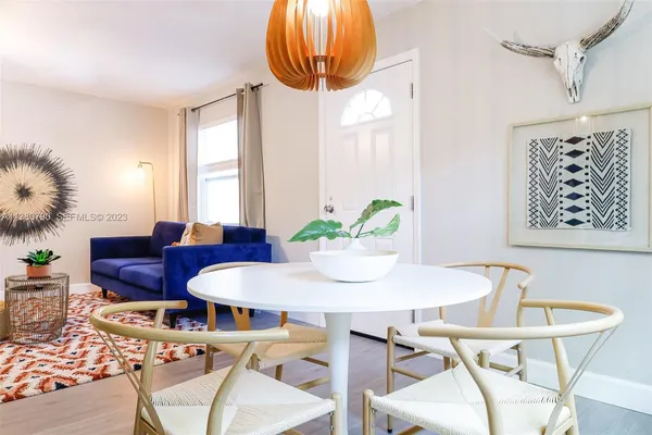 a view of a dining room with furniture and a chandelier
