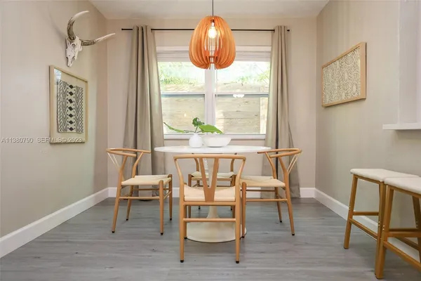 a dining room with furniture and wooden floor