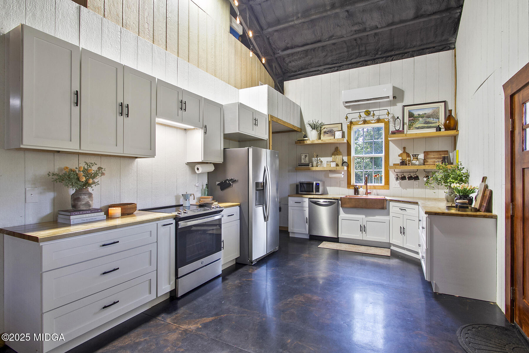 355 Dumas Road Forsyth, GA 31029 - Photo 11 of 53 a kitchen with stainless steel appliances white cabinets and wooden floors