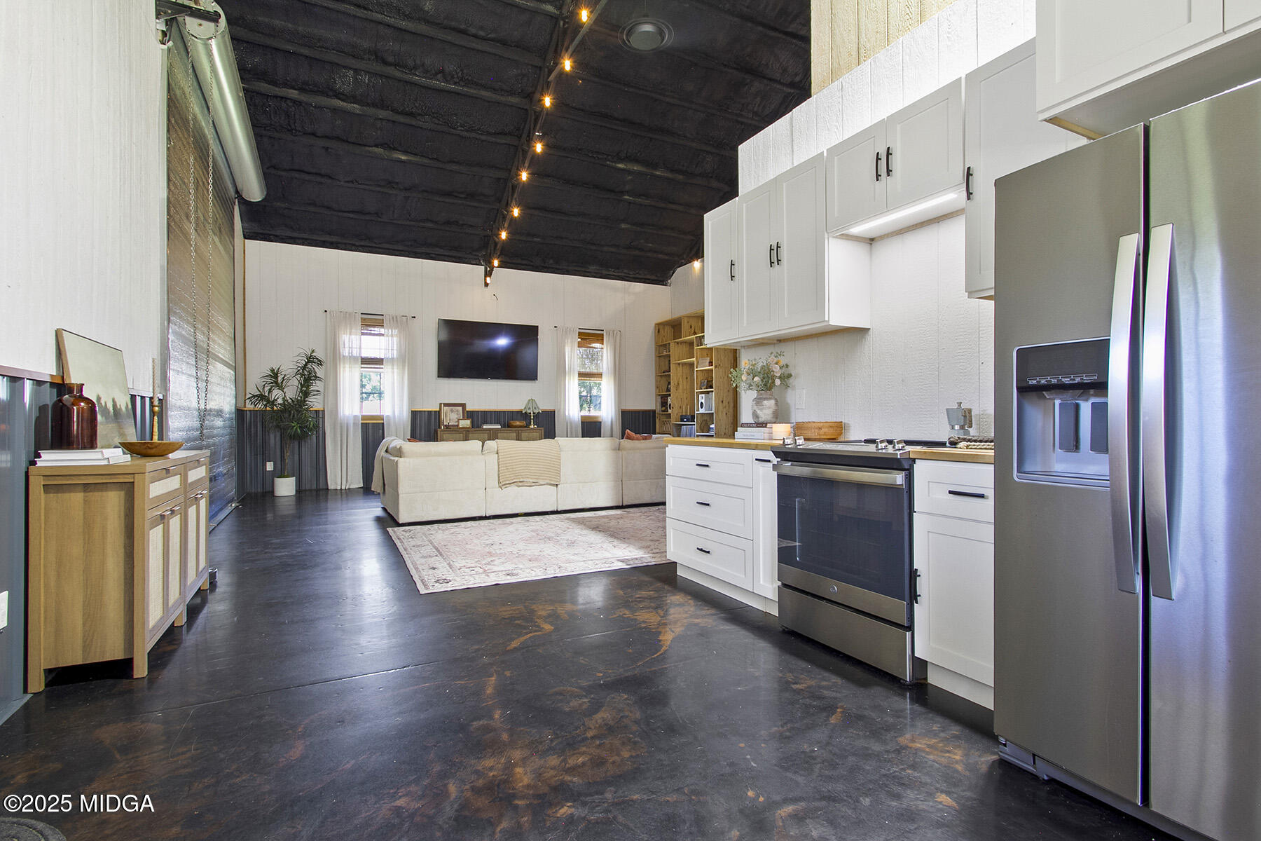 355 Dumas Road Forsyth, GA 31029 - Photo 13 of 53 a kitchen with stainless steel appliances a refrigerator a stove a sink a stove and white cabinets with wooden floor