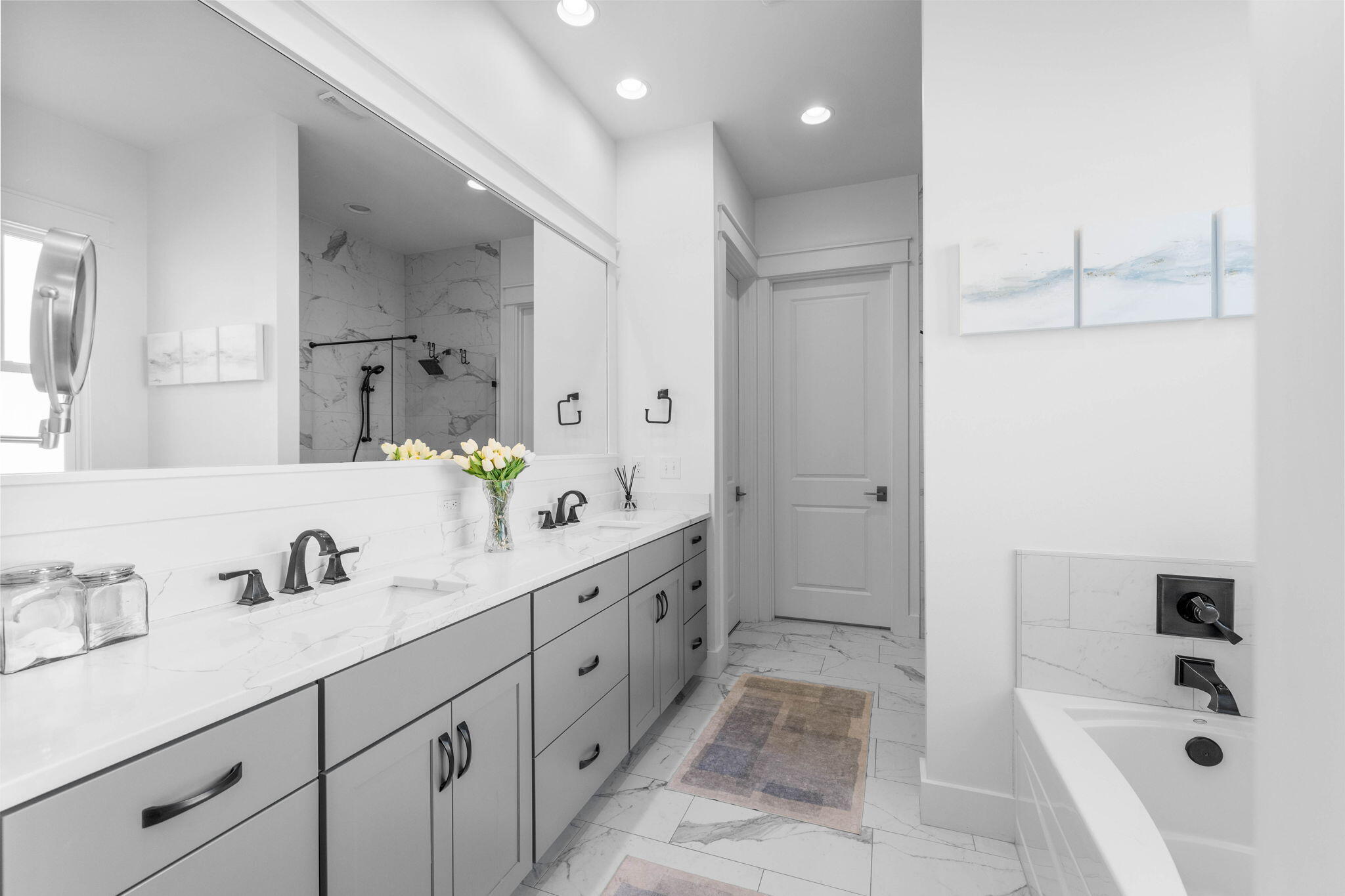 Undisclosed Address Watersound, FL 32461 - Photo 33 of 94 a bathroom with a tub sink double vanity and mirror