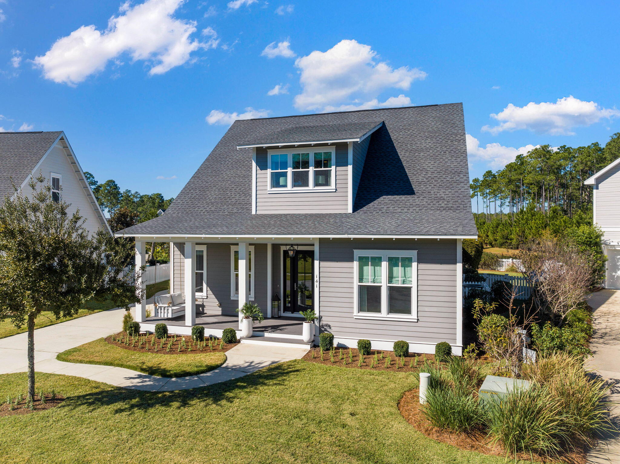Undisclosed Address Watersound, FL 32461 - Photo 66 of 94 a front view of a house with a yard table and chairs