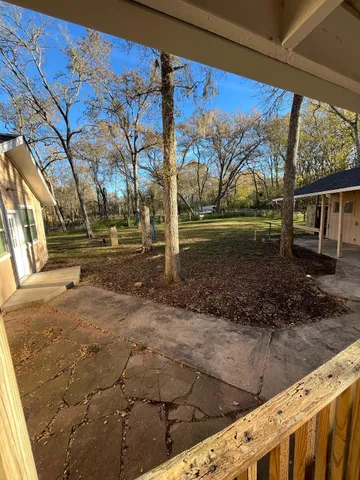 a view of a backyard with wooden fence