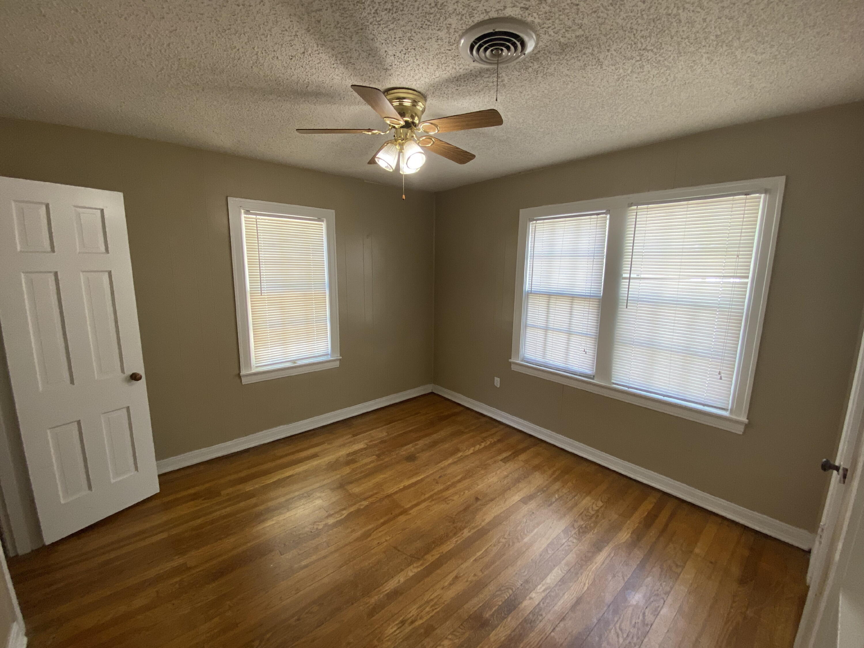 2520 27th Street, Unit FRONT Lubbock, TX 79410 - Photo 14 of 17 a view of an empty room with wooden floor and a window